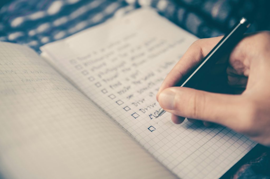 person writing a list